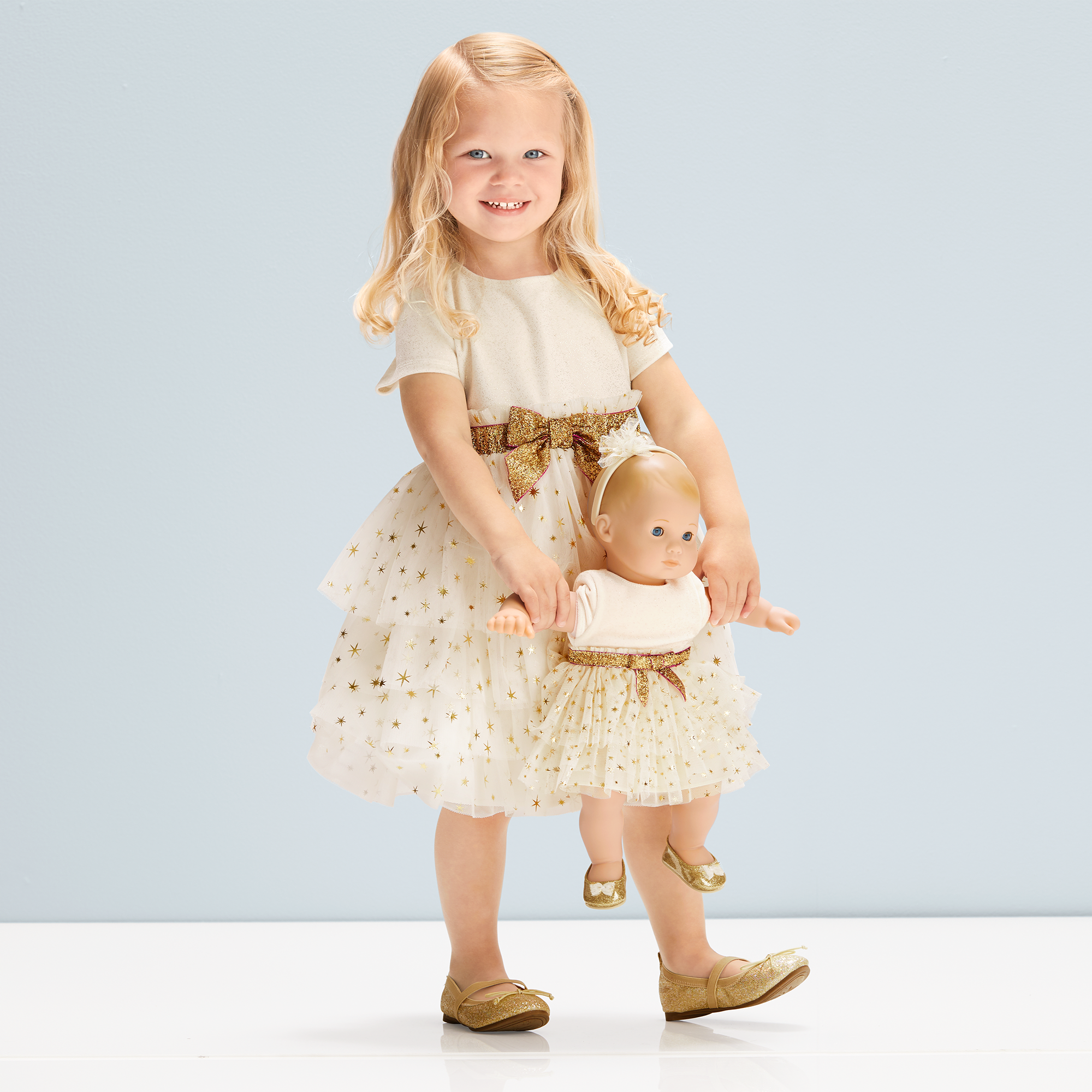 She'll sparkle and shine right along with her Bitty Baby doll in matching  holiday dresses! This set features:Golden Twinkle Dress for Little Girls: A  pretty dress with layers of mesh with sparkly